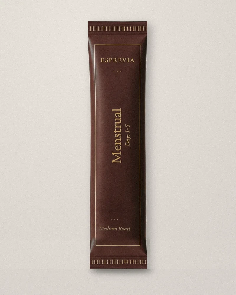 The Menstrual sachet in deep maroon with gold foil lettering.